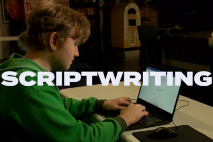 Students of diverse abilities collaborating on a script in an inclusive classroom at JDS Creative Academy, with writing materials, storyboards, and cameras visible.