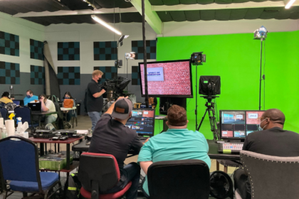 Production crew managing lighting and cameras during a live show at JDS Creative Academy.
