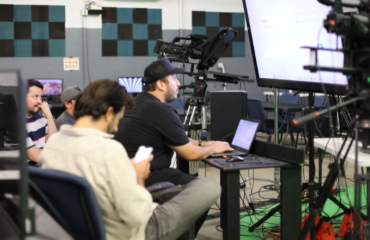 Students learning video production at JDS Creative Academy using professional cameras and editing software